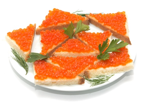 Red caviar on bread on white plate close-upの写真素材