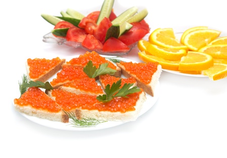 red caviar, cucumbers and tomatoes, oranges on a white backgroundの写真素材