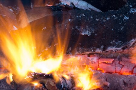 burning charcoal in the background