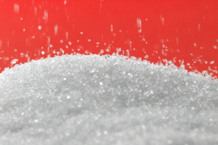 sugar on a red background. macroの写真素材