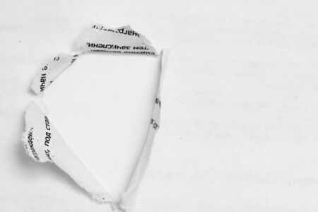 Hole ripped non color paper. White backgroundの写真素材