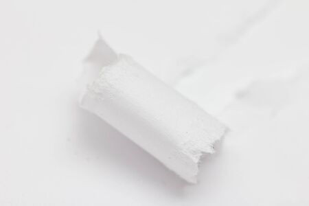 Hole ripped non color paper. White backgroundの写真素材