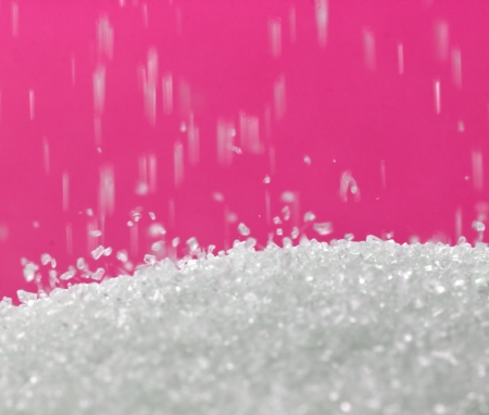 sugar on a red background. macroの写真素材