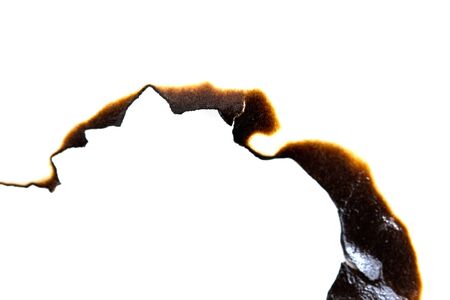 burned hole on a white paper background