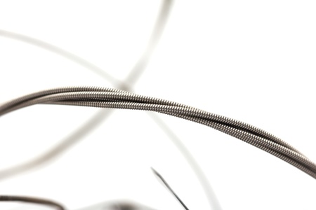 old metal strings on a white backgroundの写真素材