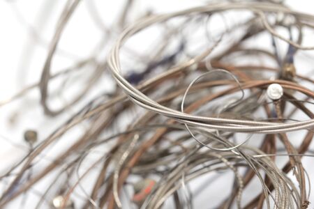 old metal strings on a white backgroundの写真素材