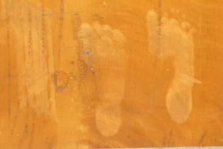 foot prints on the orange wallの写真素材