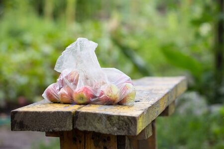 apples in a plastic bagの写真素材