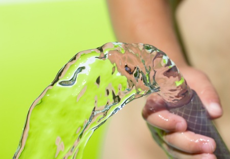 spray water from a hose child's handの写真素材