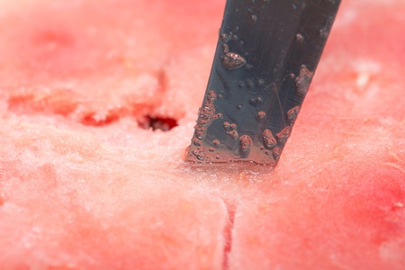 background of red watermelon with a knife. macroの写真素材