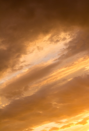 background of yellow sky with clouds at sunsetの写真素材