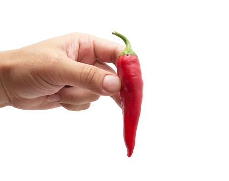 red chili peppers in hand on white backgroundの写真素材