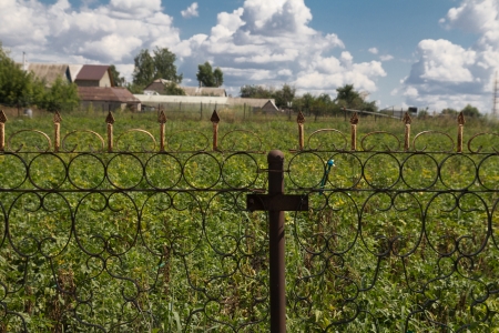 iron fence and a blue sky with cloudsの写真素材