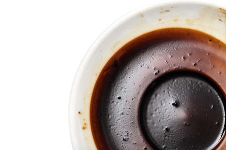 saucer with a dried coffee on a white backgroundの写真素材