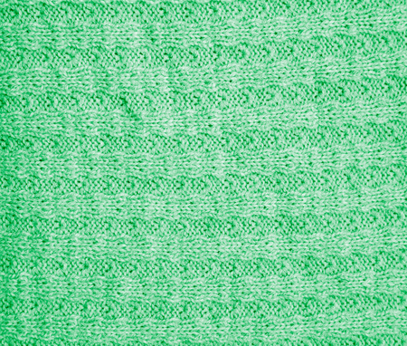 background of a green knitted fabric. texture