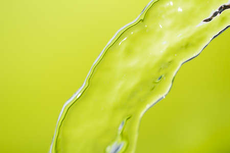 a jet of water on a green backgroundの写真素材