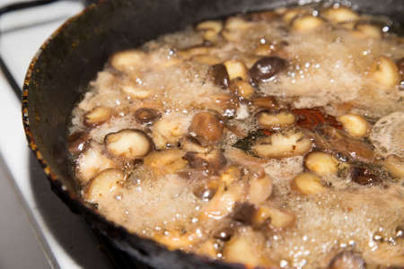 champignon mushrooms fried in a pan