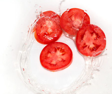 tomato in water on white backgroundの写真素材