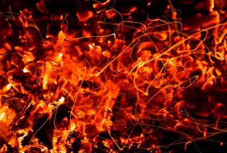 abstract background of burning coals of fire with sparksの写真素材