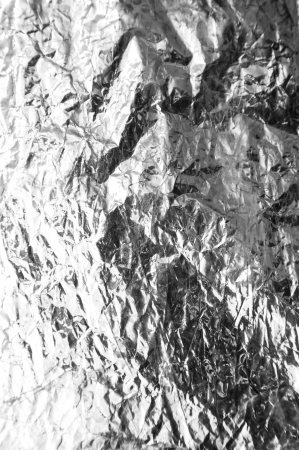 crumpled silver foil as a backgroundの写真素材