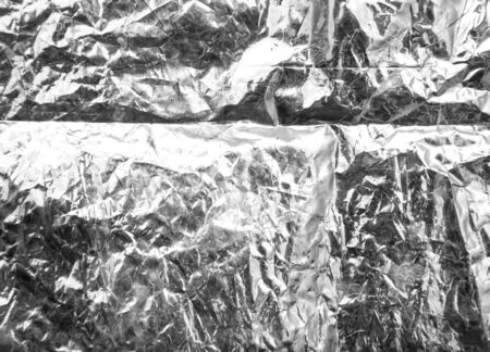crumpled silver foil as a backgroundの写真素材