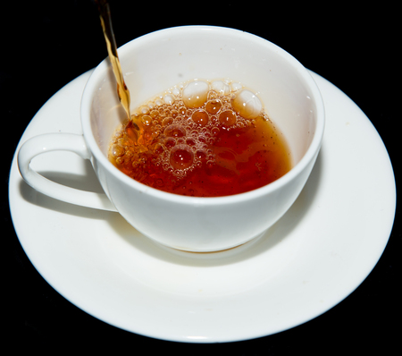 tea in a cup on a black backgroundの写真素材