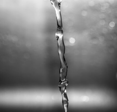 a jet of water on a gray backgroundの写真素材