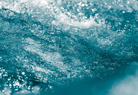 blue bubbling water from beneath the wavesの写真素材