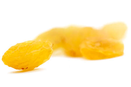 Golden raisins on a white backgroundの写真素材