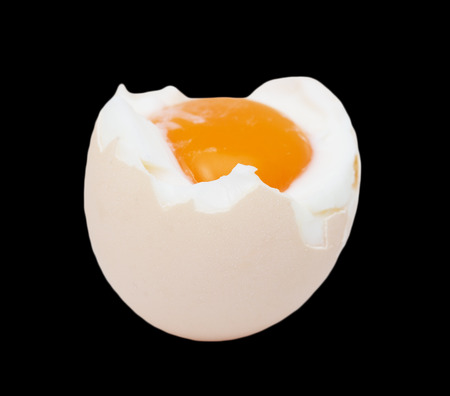 egg with yolk on black backgroundの写真素材