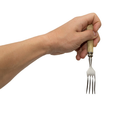 dining fork in hand on white backgroundの写真素材
