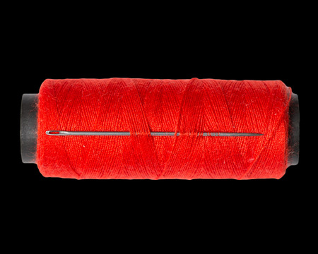 red thread on black background. macro