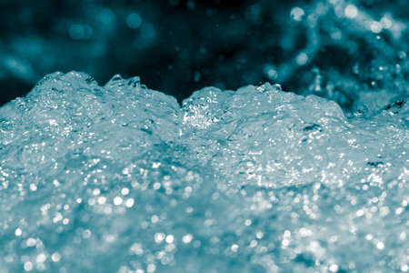 blue bubbling water from beneath the wavesの写真素材