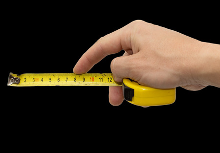 Hand with measuring tool - completely isolated on  blackの写真素材