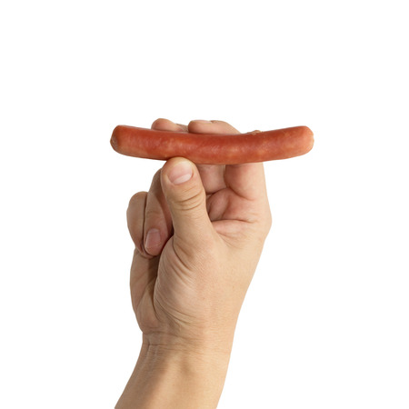 sausage in his hand on a white backgroundの写真素材