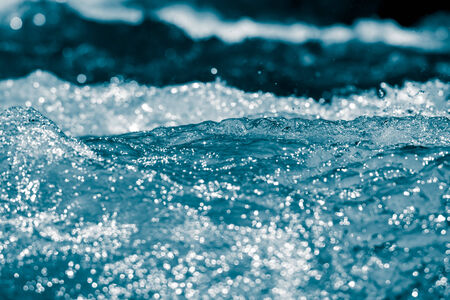 blue bubbling water from beneath the waves