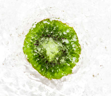 juicy kiwi fruit in water on a white background. macroの写真素材