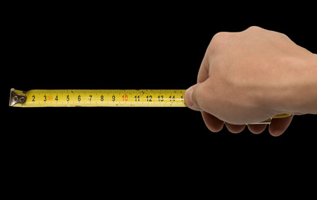 Hand with measuring tool - completely isolated on  blackの写真素材