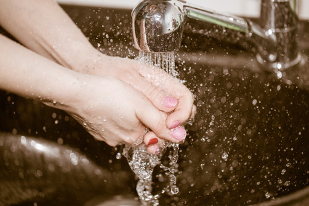 hand washing with tap waterの写真素材