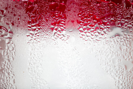 Abstract background of water drops on a red backgroundの写真素材