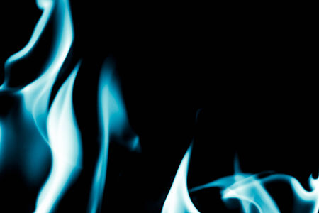abstract background of blue flame fire on black backgroundの写真素材