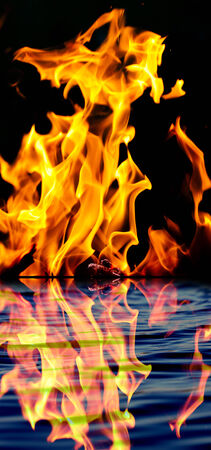 fire with reflection on waterの写真素材