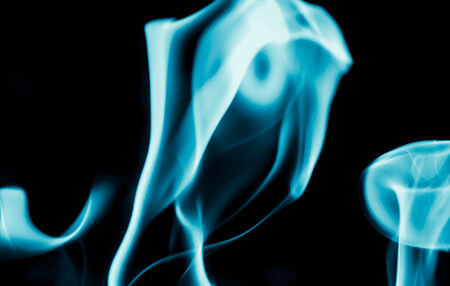 abstract background of blue flame fire on black backgroundの写真素材