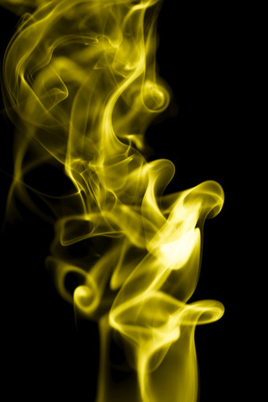 yellow smoke on a black backgroundの写真素材