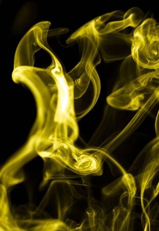 yellow smoke on a black backgroundの写真素材