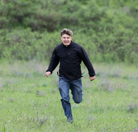 man running in a meadow
