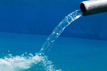 Water is poured into a poolの写真素材