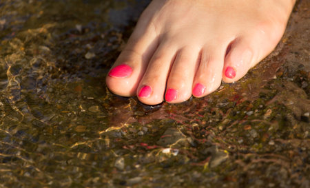 pedicure on foot in the water on the rocks