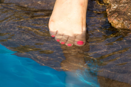 pedicure on foot in the water on the rocks