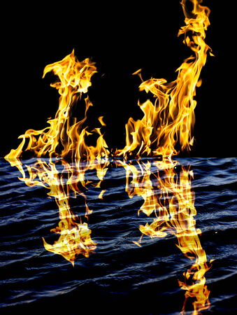 flame fire with reflection in waterの写真素材